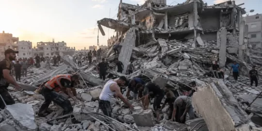War-damaged building collapses in Gaza City, killing at least 21